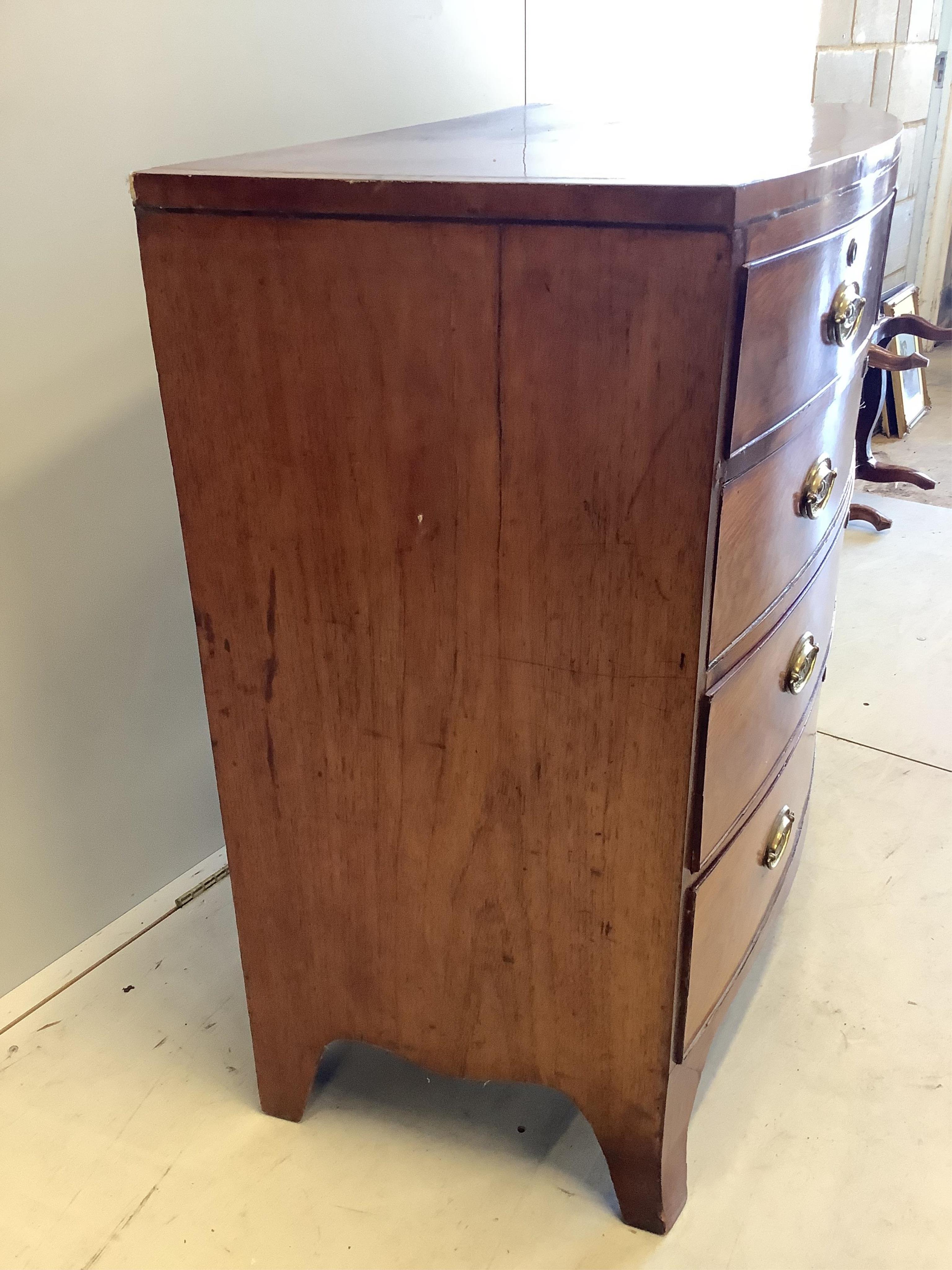 A Regency banded mahogany bowfronted chest, fitted two short and three long drawers, with oval stamped brass handles, width 103cm, depth 54cm, height 97cm. Condition - poor to fair